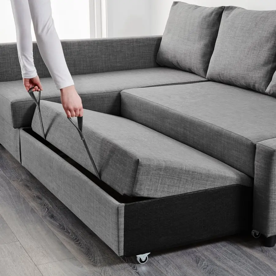 A hand pulling the base forward by its strap to make the bed